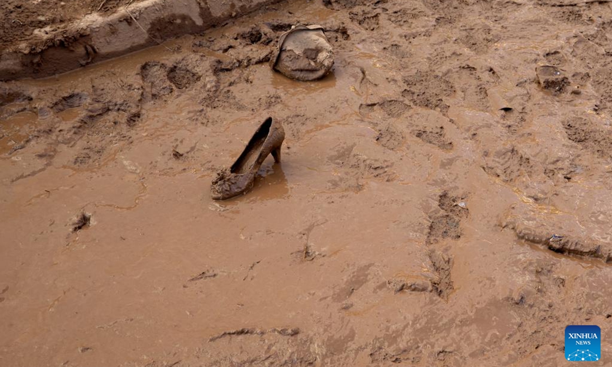 A high-heeled shoe is pictured in mud after flood in Utiel, Spain, Nov. 2, 2024. Torrential rains over recent days have triggered Spain's worst flooding in decades. The death toll from the flooding had risen to 211 as of Saturday morning, according to the government.    (Photo: Xinhua)