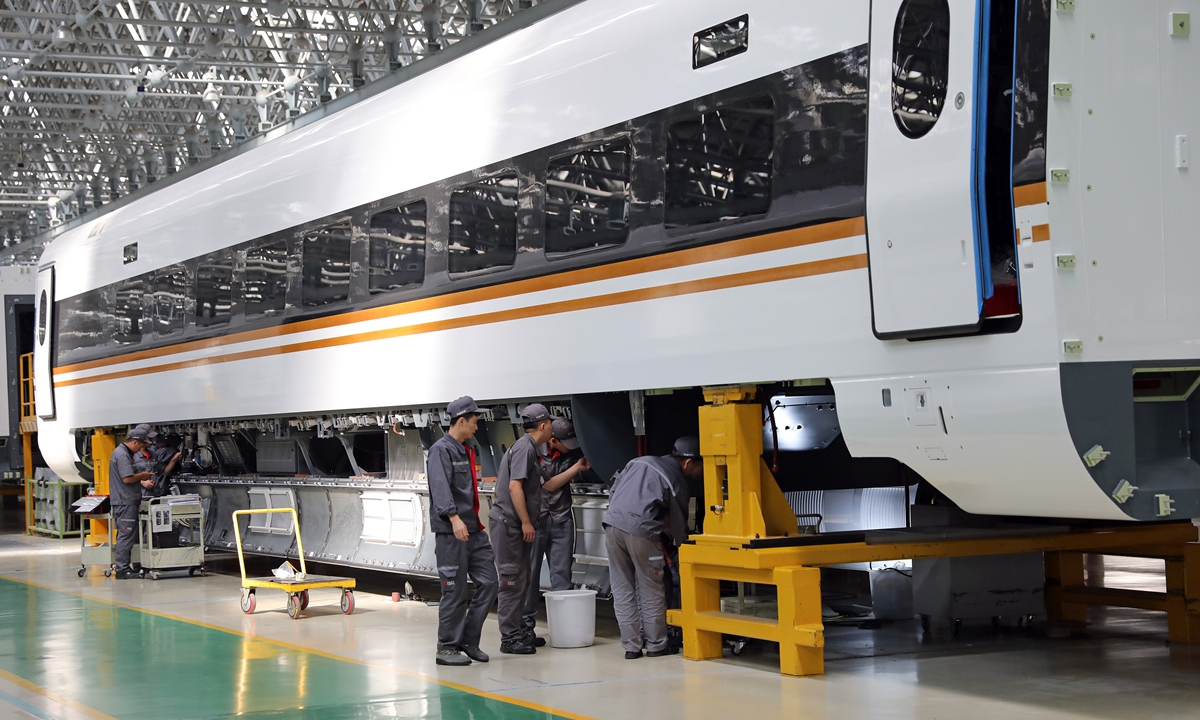 Workers at the workshop of CRRC Changchun assemble a bullet train. Photo: IC