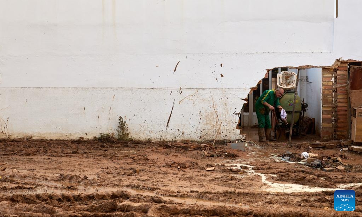 A resident clears his residence after flood in Utiel, Spain, Nov. 2, 2024. Torrential rains over recent days have triggered Spain's worst flooding in decades. The death toll from the flooding had risen to 211 as of Saturday morning, according to the government.    (Photo: Xinhua)