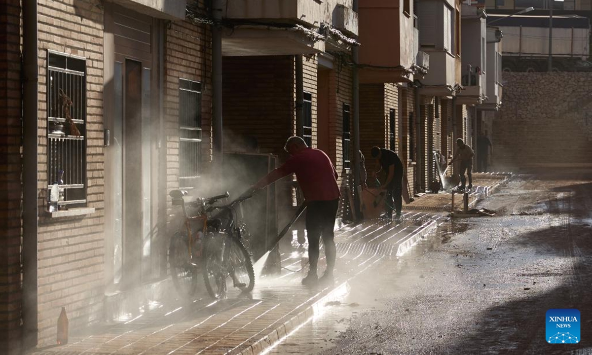 Residents clean their belongings after flood in Utiel, Spain, Nov. 2, 2024. Torrential rains over recent days have triggered Spain's worst flooding in decades. The death toll from the flooding had risen to 211 as of Saturday morning, according to the government. (Photo: Xinhua)