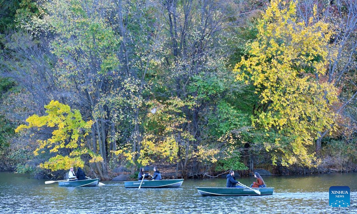 People row boats with fall foliage as their backdrop at Central Park in New York, the United States, on Nov. 2, 2024. (Photo: Xinhua)