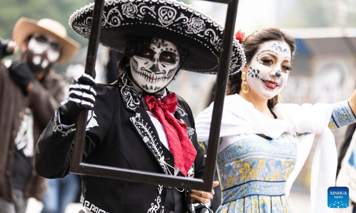 People in costumes and facial makeup participate in the Day of the Dead Parade in downtown Mexico City, capital of Mexico, on Nov. 2, 2024. (Photo: Xinhua)