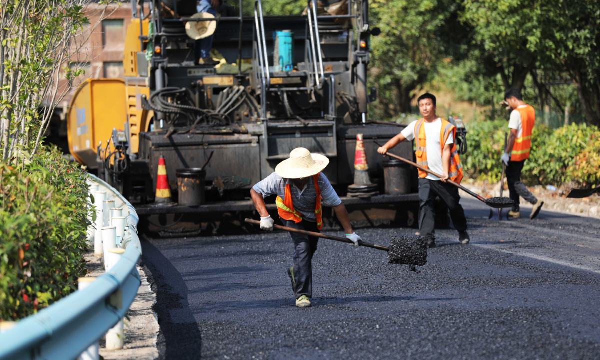 Construction workers lay asphalt on a road in Xinhua town, Jinping county in Qiandongnan Miao and Dong Autonomous Prefecture, Southwest China’s Guizhou Province, on September 12, 2024. Photo: VCG 