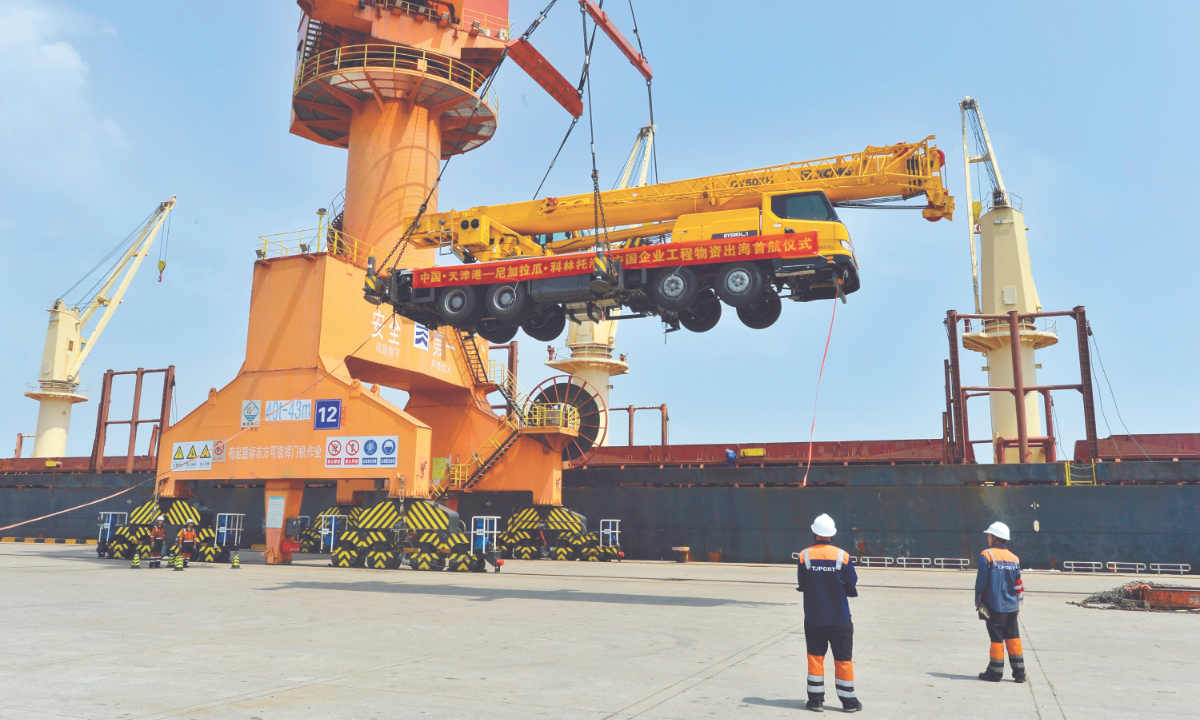 A Chinese-made construction vehicle is lifted onto a ship at Tianjin Port, North China, on June 13, 2024. The ship is bound for Corinto Port, Nicaragua. Photo: VCG