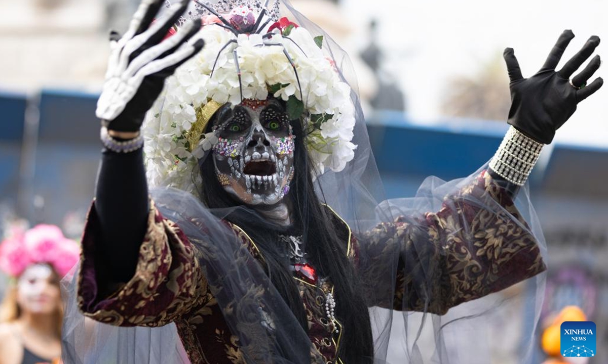 A dressed-up woman participates in the Day of the Dead Parade in downtown Mexico City, capital of Mexico, on Nov. 2, 2024.  (Photo: Xinhua)