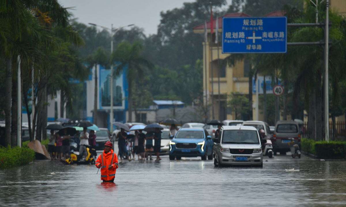 Residents of Jiaji Township in Qionghai, South China's Hainan Province, deal with flooding on November 4, 2024. A new round of heavy rainfall has hit Hainan due to the influence of cold air and warm and humid airflow from the south-east. Photo: VCG