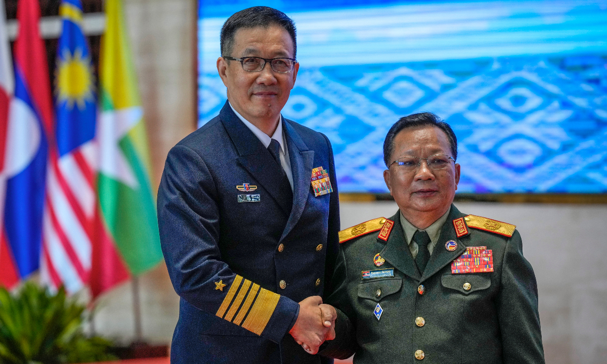 Chinese Defence Minister Dong Jun (left) meets Laos' Defence Minister Chansamone Chanyalath during the ASEAN defense ministers' meeting in Vientiane, Laos, on November 21, 2024. Photo: VCG