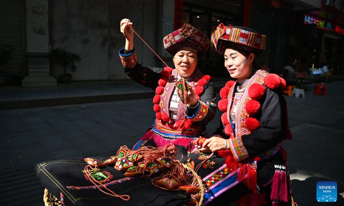 Pan Haiyan (L) shows embroidery techniques to her apprentice in her workshop in Tianlin County, Baise City, south China's Guangxi Zhuang Autonomous Region, Oct. 31, 2024. (Photo: Xinhua)