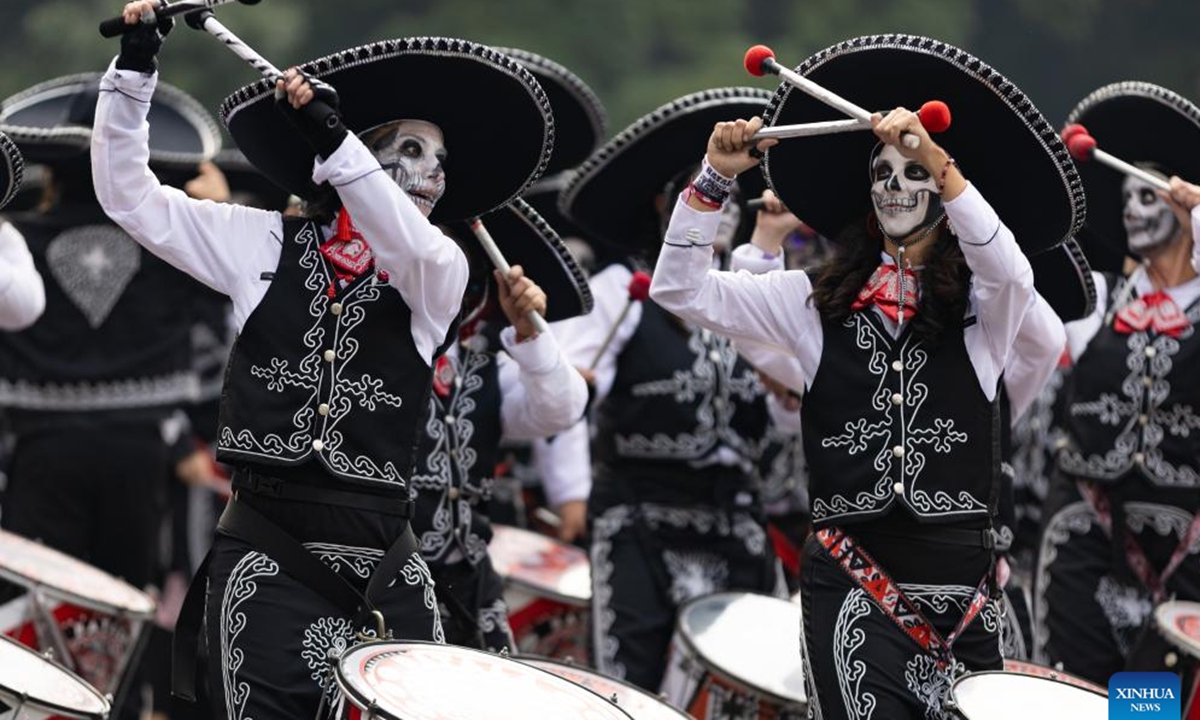 People in costumes and facial makeup participate in the Day of the Dead Parade in downtown Mexico City, capital of Mexico, on Nov. 2, 2024.  (Photo: Xinhua)