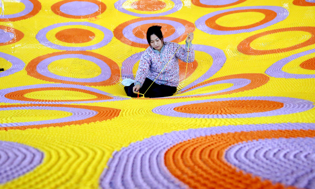 A worker is weaving nets for children’s entertainment facilities at a sports rope net company in Binzhou, East China’s Shandong Province on November 28, 2024. Photo: IC