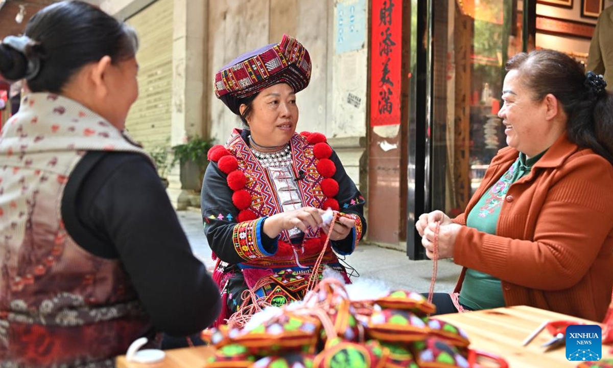 Pan Haiyan (C) teach embroidery techniques to her apprentices in her embroidery workshop in Tianlin County, Baise City, south China's Guangxi Zhuang Autonomous Region, Oct. 31, 2024. (Photo: Xinhua)