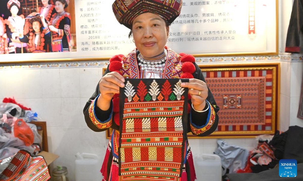 Pan Haiyan displays her embroidery work in her workshop in Tianlin County, Baise City, south China's Guangxi Zhuang Autonomous Region, Oct. 31, 2024. (Photo: Xinhua)