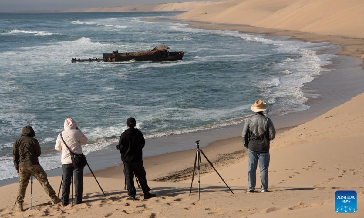 Tourists take photos of the Meob Bay at the Namib-Naukluft National Park in Namibia, Nov. 2, 2024. (Photo: Xinhua)