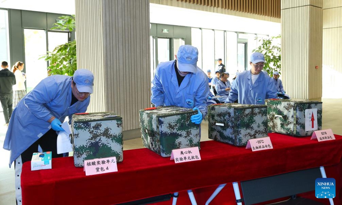 Researchers examine packages containing space station experimental samples brought back by the Shenzhou-18 spacecraft at the Technology and Engineering Center for Space Utilization under the Chinese Academy of Sciences in Beijing, capital of China, Nov. 4, 2024. (Technology and Engineering Center for Space Utilization under the Chinese Academy of Sciences/Handout via Xinhua)