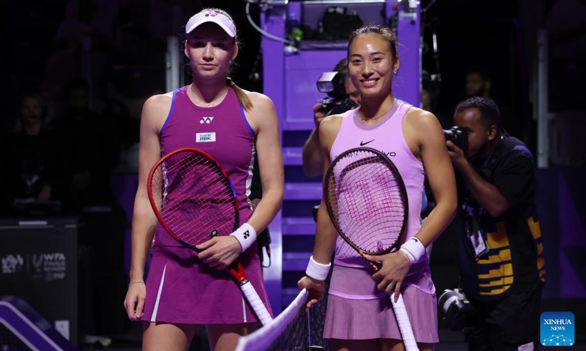 Zheng Qinwen (R) of China and Elena Rybakina of Kazakhstan pose for photos before their round robin match at WTA Finals tennis tournament in Riyadh, Saudi Arabia, Nov. 4, 2024. (Photo: Xinhua)