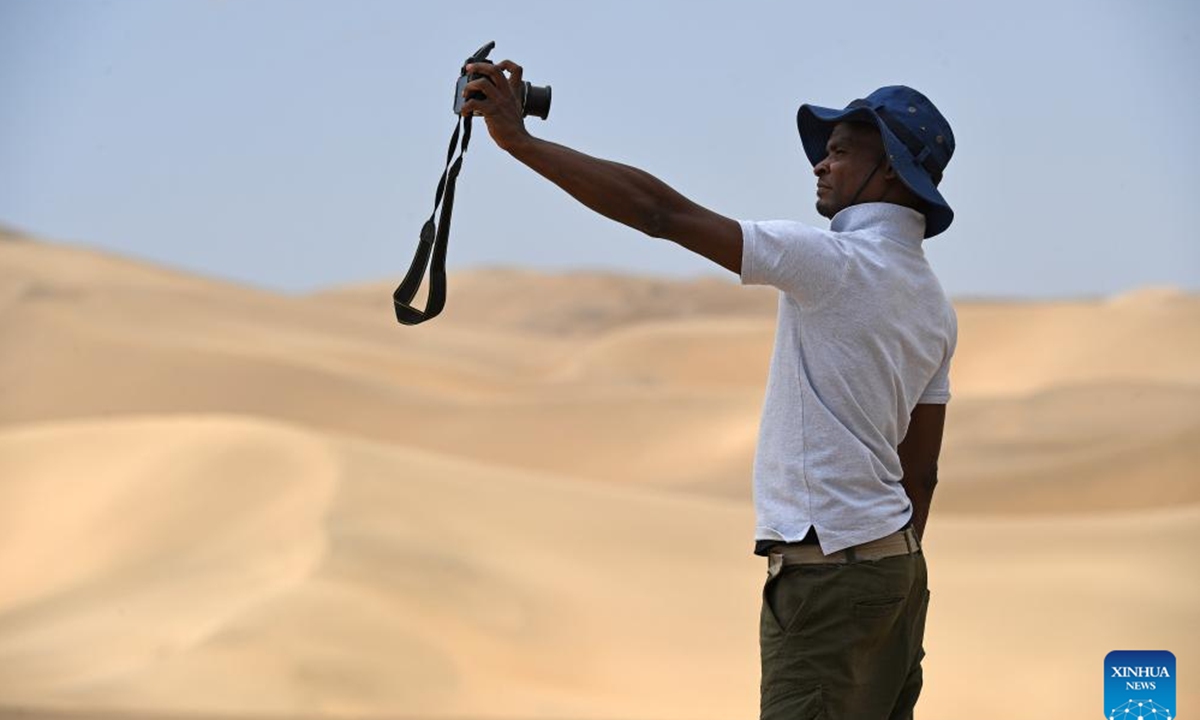 A tourist takes selfies at the Namib-Naukluft National Park in Namibia, Nov. 2, 2024. (Photo: Xinhua)