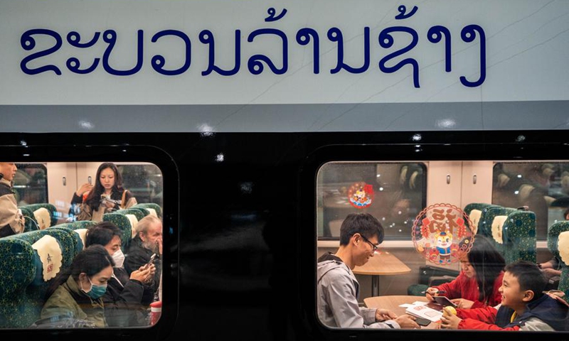 Passengers bound for Laos are aboard a China-Laos Railway train at Kunming South Railway Station in Kunming, southwest China's Yunnan Province, Feb. 14, 2024. (Xinhua/Hu Chao)