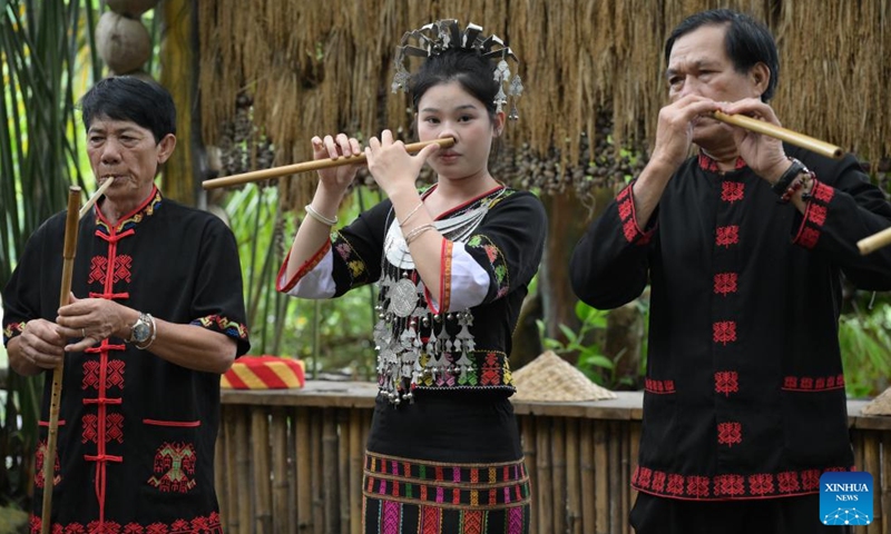 Musicians perform traditional musical instruments made of bamboo at Binglanggu tourism area in Baoting Li and Miao Autonomous County, south China's Hainan Province, Nov. 4, 2024. (Photo: Xinhua)