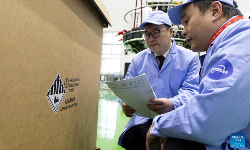 Customs officers check the packages for the Solar wind Magnetosphere Ionosphere Link Explorer (SMILE) at a workshop of the Innovation Academy for Microsatellites of Chinese Academy of Sciences (CAS) in Shanghai, east China, Nov. 4, 2024. (Photo: Xinhua)