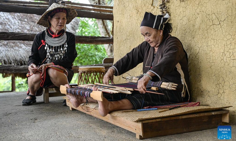 A senior Li woman demonstrates a traditional weaving technique at Binglanggu tourism area in Baoting Li and Miao Autonomous County, south China's Hainan Province, Nov. 4, 2024. (Photo: Xinhua)