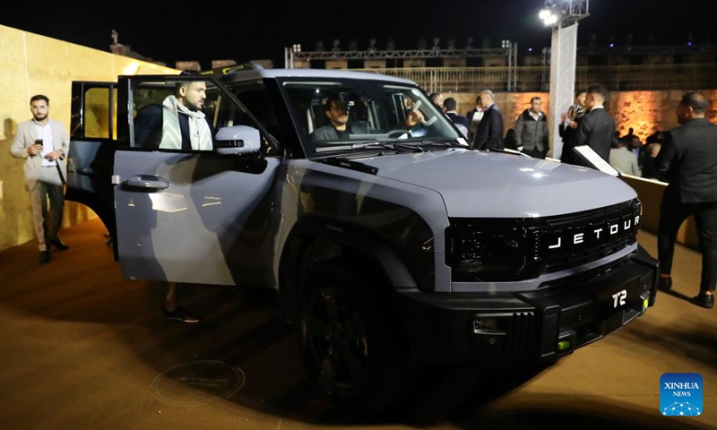 Visitors try a new car at the launching ceremony of Jetour Auto's first off-road SUV model T2 in Cairo, Egypt, Nov. 4, 2024. (Photo: Xinhua)