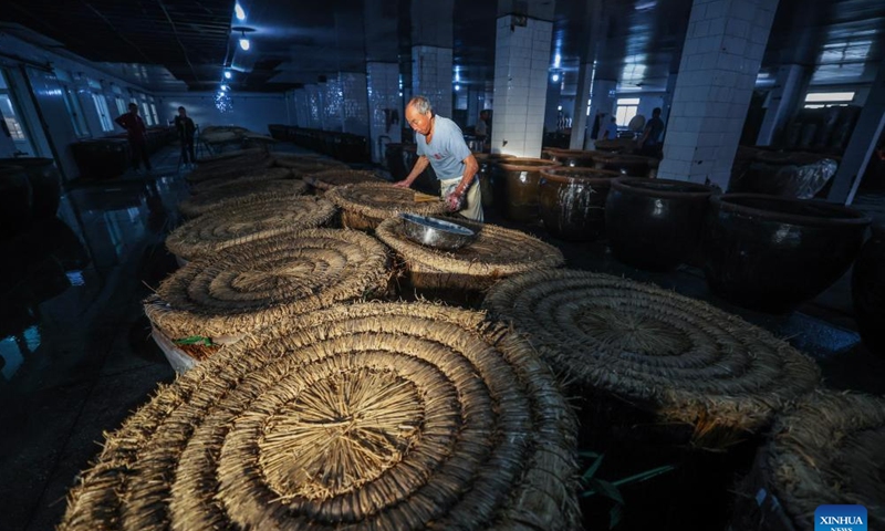 A staff member works at Shendang Winery Co., Ltd. in Haiyan County of Jiaxing City, east China's Zhejiang Province, Nov. 9, 2024. Shendang Winery Co., Ltd., a century-old winery in Shendang Ancient Town in Jiaxing, held a start-of-winter brewing ceremony for yellow rice wine on Saturday. The ceremony is a tradition observed around Lidong, or Start of Winter, the 19th of the 24 solar terms in the Chinese lunar calendar. (Xinhua/Xu Yu)