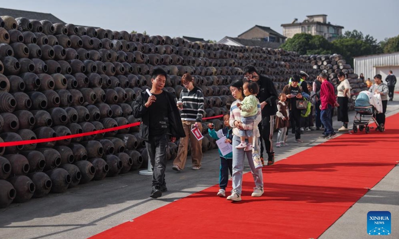 Tourists visit Shendang Winery Co., Ltd. in Haiyan County of Jiaxing City, east China's Zhejiang Province, Nov. 9, 2024. Shendang Winery Co., Ltd., a century-old winery in Shendang Ancient Town in Jiaxing, held a start-of-winter brewing ceremony for yellow rice wine on Saturday. The ceremony is a tradition observed around Lidong, or Start of Winter, the 19th of the 24 solar terms in the Chinese lunar calendar. (Xinhua/Xu Yu)