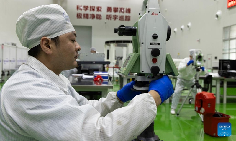 A technician measures the Solar wind Magnetosphere Ionosphere Link Explorer (SMILE) at a workshop of the Innovation Academy for Microsatellites of Chinese Academy of Sciences (CAS) in Shanghai, east China, Nov. 4, 2024. (Photo: Xinhua)