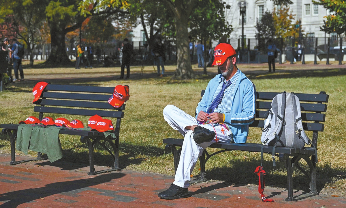 A supporter of US President-elect Donald Trump sells merchandise near the White House in Washington DC, on November 6, 2024.? Photo: VCG