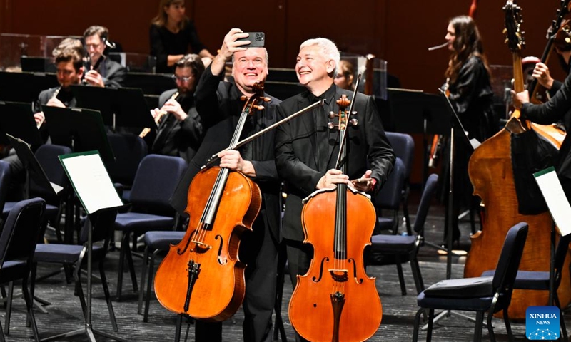 Members of the Philadelphia Orchestra take selfies during the breaks in the performance in Haikou, south China's Hainan Province, Nov. 9, 2024. The American orchestra staged a concert in Haikou on Saturday. (Xinhua/Yang Guanyu)