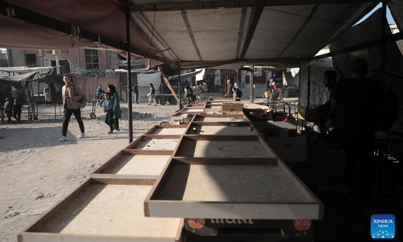 People are seen at an empty market in the southern Gaza Strip city of Khan Younis, on Nov. 5, 2024. Markets in central and southern Gaza seemed unusually empty on Tuesday, with only a handful of vendors selling their products at what they claimed were good prices.  (Photo: Xinhua)