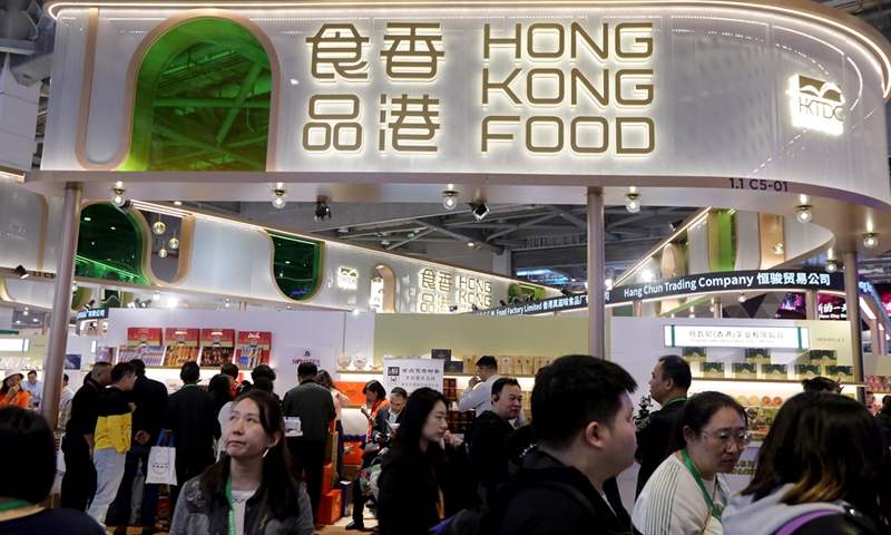 Visitors explore the Hong Kong food exhibitions and try specialties at the 7th China International Import Expo in Shanghai on November 6, 2024. Photo: Chen Xia/GT