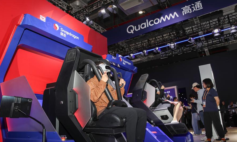 Visitors experience smart devices equipped with Qualcomm Snapdragon chips at the booth of Qualcomm, a full-time attender of the China International Import Expo (CIIE), during the 7th CIIE in east China's Shanghai, Nov. 9, 2024. (Photo by Chang Nengjia/Xinhua)