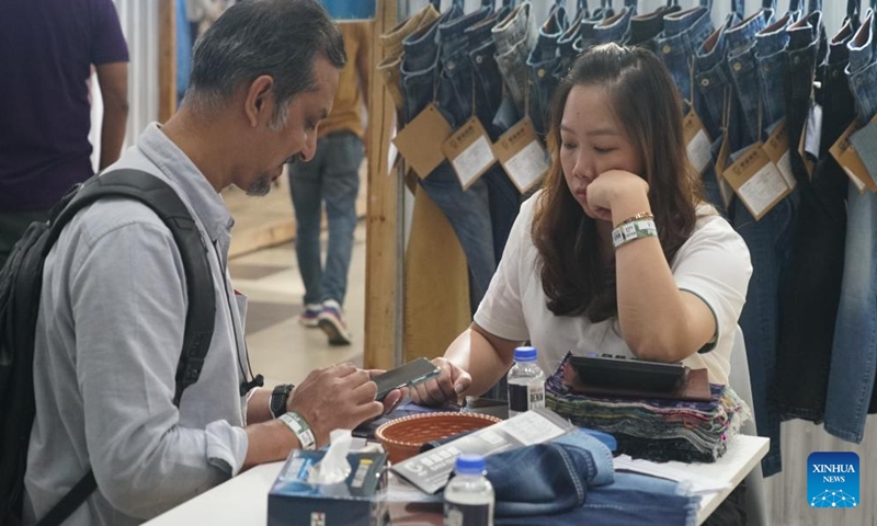 A man visits a booth at the 17th edition of Bangladesh's largest denim exposition in Dhaka, Bangladesh, Nov. 4, 2024.  (Photo: Xinhua)