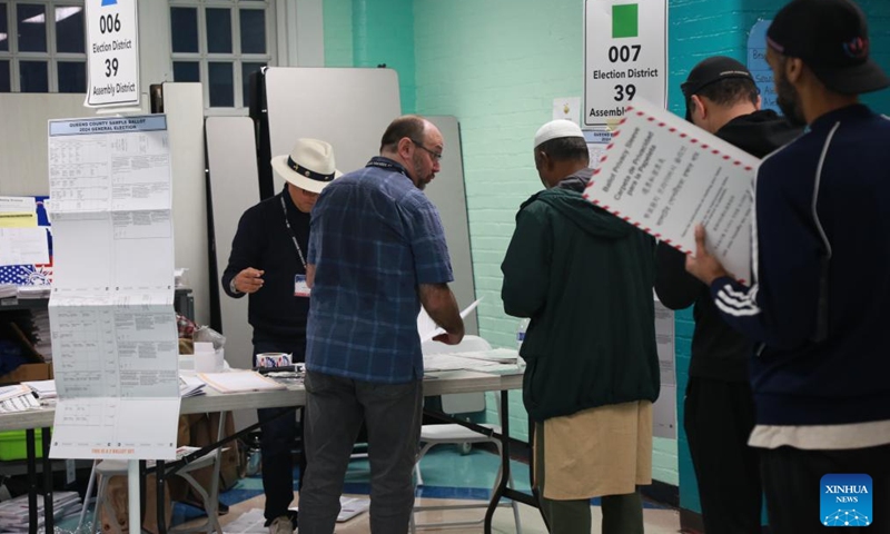 Voters line up to verify their identification at a polling station during the 2024 U.S. presidential election in Queens, New York City, the United States, Nov. 5, 2024.  (Photo: Xinhua)