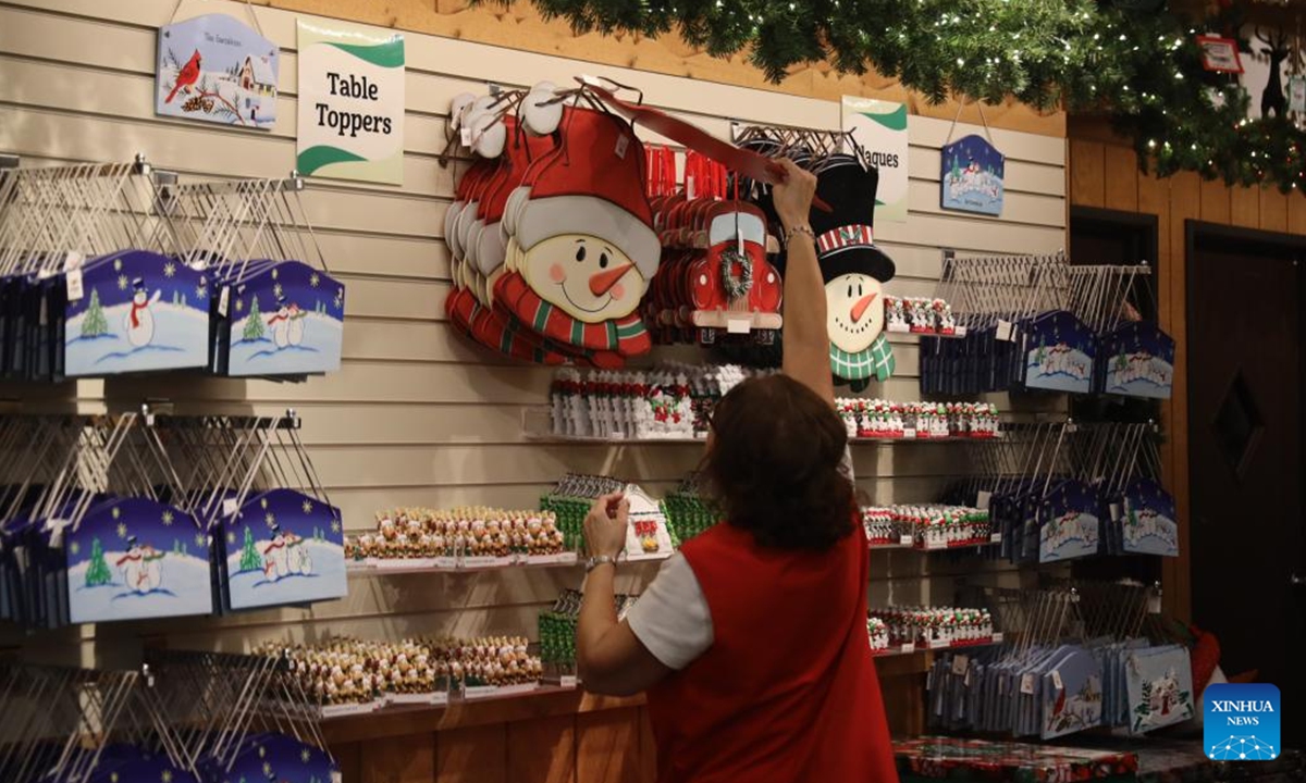 A store clerk arranges items at Bronner's CHRISTmas Wonderland in Frankenmuth, Michigan, the United States, on Oct. 30, 2024. Bronner's CHRISTmas Wonderland in Frankenmuth is striving to recover from the COVID-19 pandemic while shoppers are returning and sales climbing up, according to staff members and customers interviewed by Xinhua reporters there at the end of October.  (Photo: Xinhua)