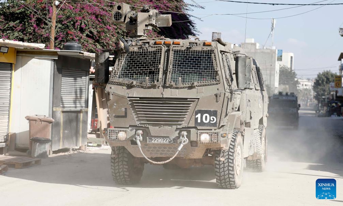 Israeli military vehicles are seen during an Israeli raid in the Jenin refugee camp, northern West Bank, on Nov. 6, 2024.  (Photo: Xinhua)