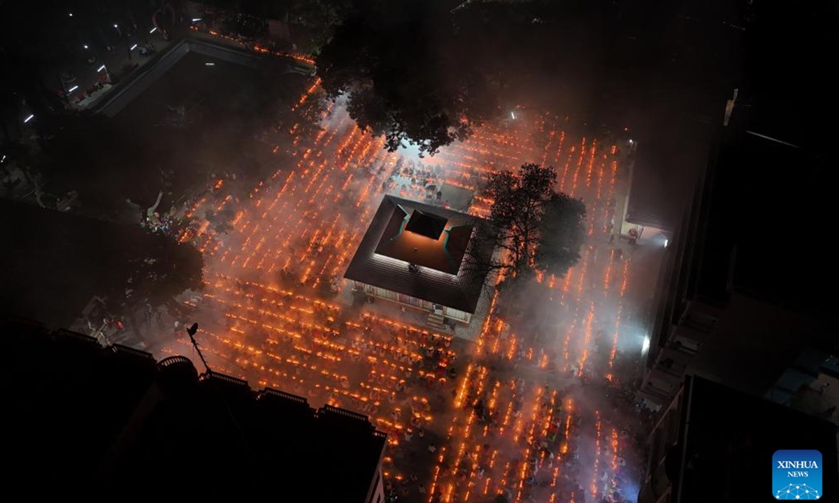 An aerial drone photo shows devotees attending the Rakher Upobash, a religious fasting festival, with burning incense and light oil lamps at a temple in Narayanganj, Bangladesh, on Nov. 5, 2024.  (Photo: Xinhua)