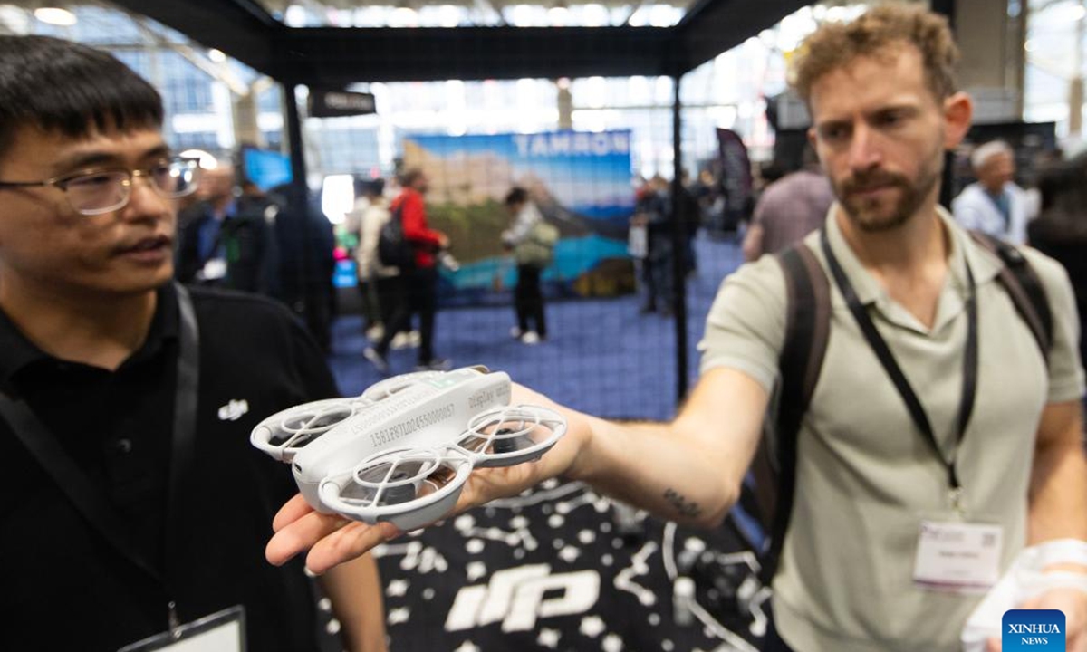 A man (R) experiences a DJI drone at the ProFusion Expo 2024 in Toronto, Canada, on Nov. 6, 2024. As one of the largest photo and video events in Canada, this annual two-day event kicked off here on Wednesday, attracting many imaging professionals and enthusiasts.  (Photo: Xinhua)