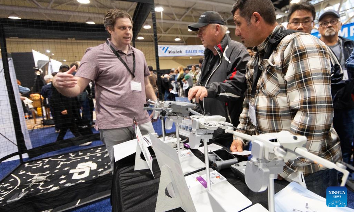 People visit the booth of Chinese drone maker DJI at the ProFusion Expo 2024 in Toronto, Canada, on Nov. 6, 2024. As one of the largest photo and video events in Canada, this annual two-day event kicked off here on Wednesday, attracting many imaging professionals and enthusiasts. (Photo: Xinhua)