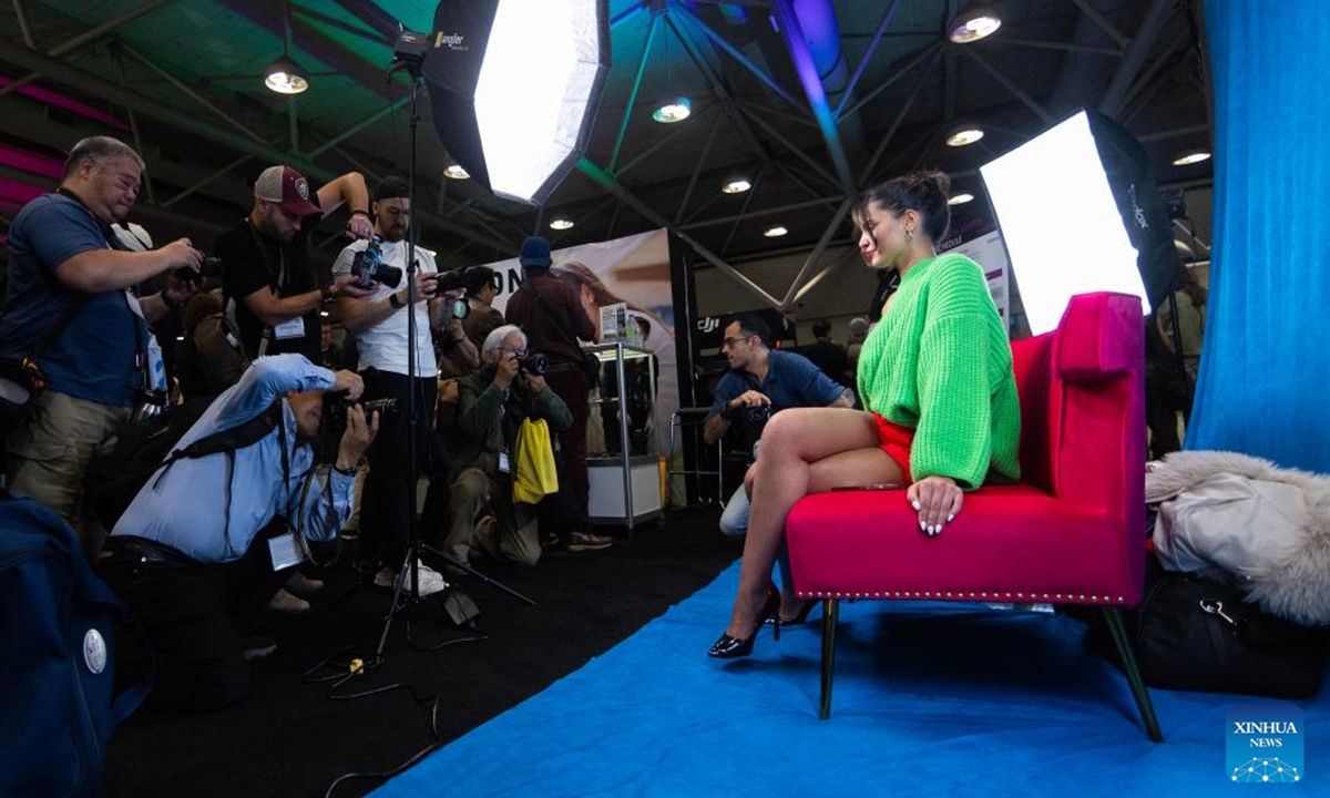 A woman poses for portrait photos at the ProFusion Expo 2024 in Toronto, Canada, on Nov. 6, 2024. As one of the largest photo and video events in Canada, this annual two-day event kicked off here on Wednesday, attracting many imaging professionals and enthusiasts. (Photo: Xinhua)