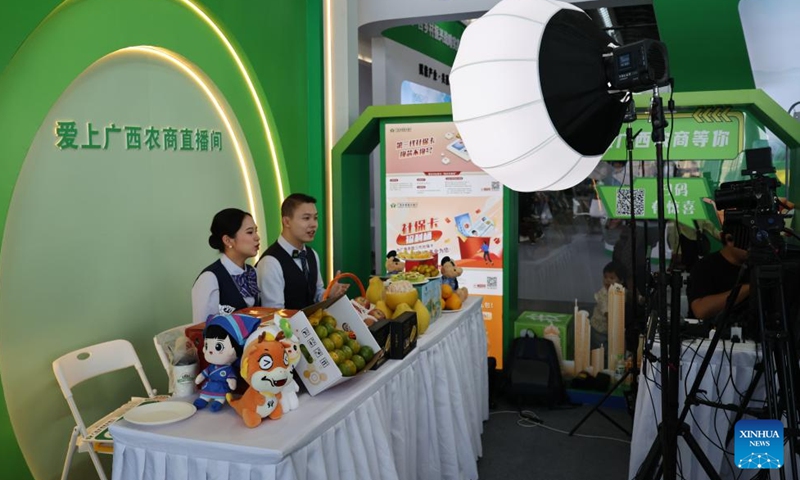 Exhibitors promote products via livestream during the 2024 Guangxi International Agricultural Expo in Nanning, south China's Guangxi Zhuang Autonomous Region, Nov. 8, 2024. (Photo: Xinhua)