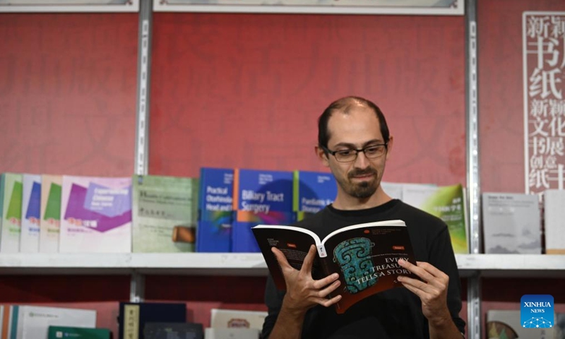 A man reads a book at the Chinese exhibition booth during the Malta Book Festival in Ta' Qali, Attard, Malta, on Nov. 6, 2024. A delegation of Chinese publishers, alongside the China Cultural Center in Malta, showcased a variety of Chinese publications at the 45th Malta Book Festival, which runs from Nov. 6 to Nov. 10 in Attard, central Malta. (Photo: Xinhua)