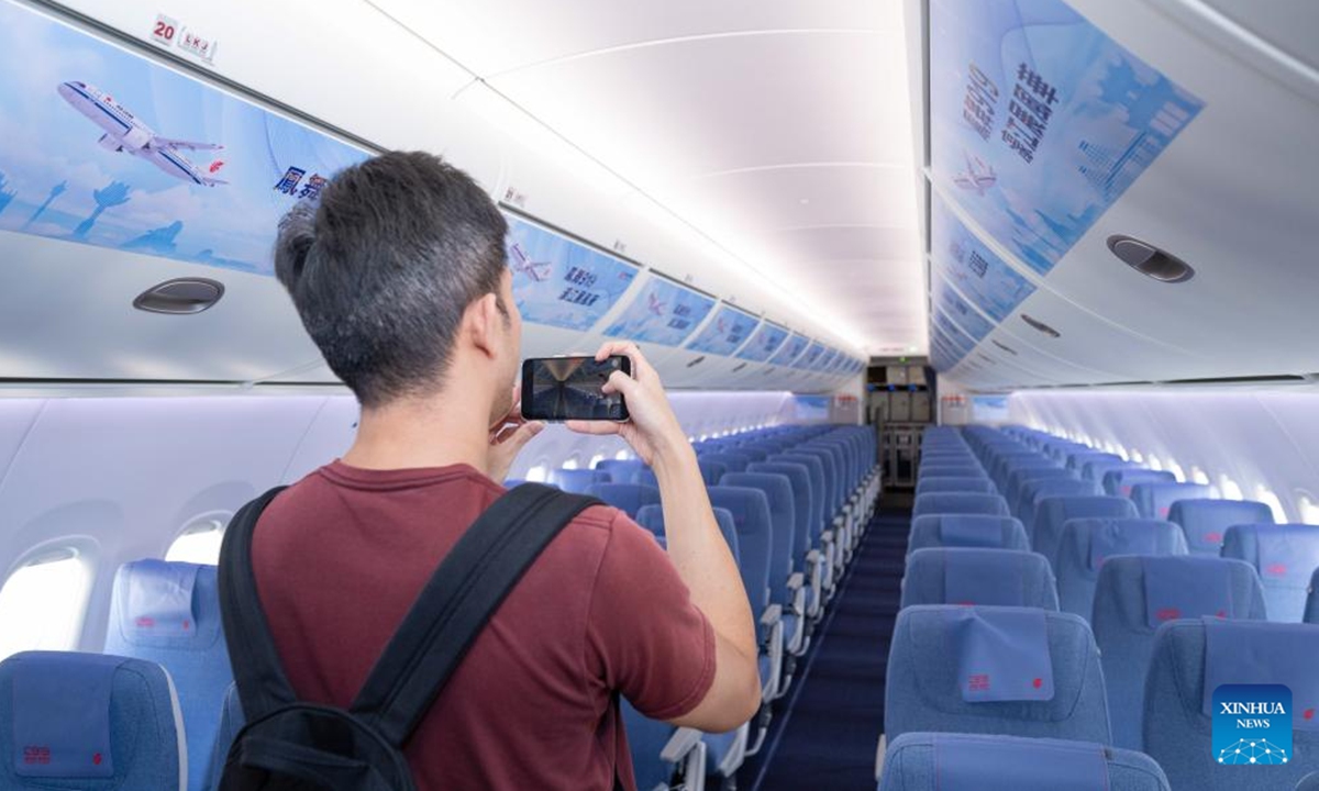 A journalist takes photos on the C919 aircraft at Macao International Airport in Macao, south China, Nov. 7, 2024. Air China's B-919Y aircraft completed a flight to the Macao Special Administrative Region (SAR) on Thursday, marking the first visit of China's homegrown C919 jetliner to Macao, as well as the inaugural flight since the delivery of the B-919Y aircraft.  (Photo: Xinhua)