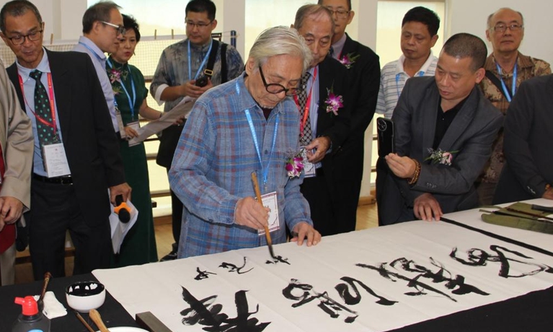 A participant writes Chinese calligraphy at the fifth International Chinese Calligraphy Grand Exhibition in Bandar Seri Begawan, capital of Brunei, Nov. 8, 2024. (Photo: Xinhua)