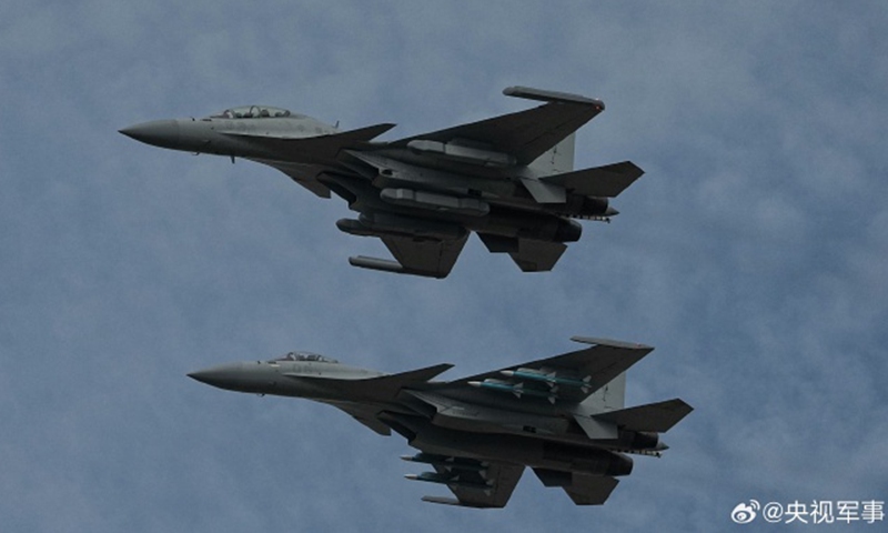 The J-15D carrier-borne electronic warfare aircraft (front) and the J-15T carrier-borne fighter jet of the Chinese People’s Liberation Army (PLA) Navy conduct an adaptive training in a formation in Zhuhai, South China’s Guangdong Province on November 9, 2024 ahead of Airshow China 2024.