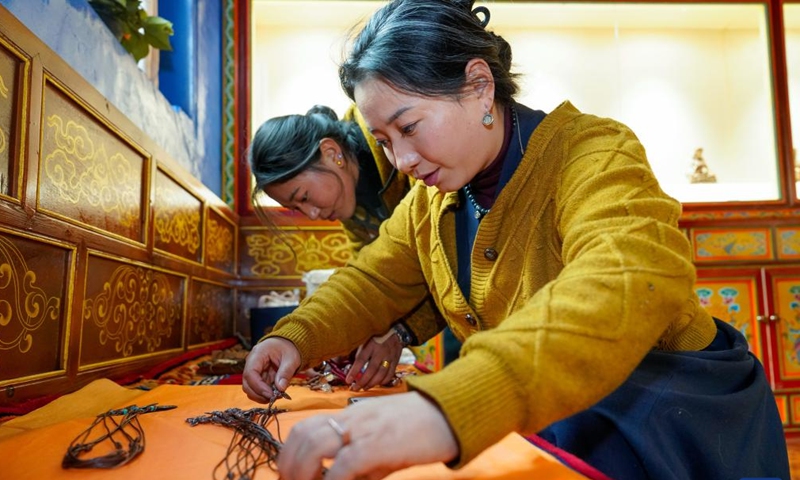 Dawa Drolma (front) and her colleague arrange products to be delivered in Maisu Town of Dege County in Garze Tibetan Autonomous Prefecture, southwest China's Sichuan Province, Nov. 3, 2024. (Photo: Xinhua)