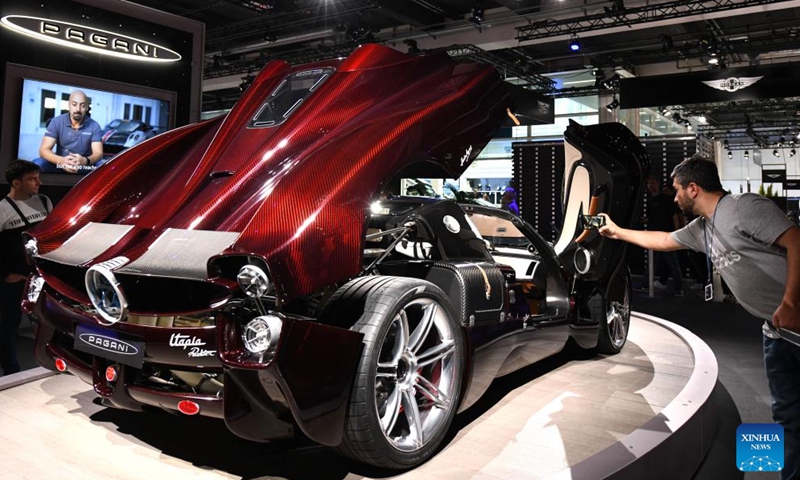 A visitor takes photos of a car at the Auto Zurich 2024 in Zurich, Switzerland, Nov. 8, 2024. (Photo: Xinhua)