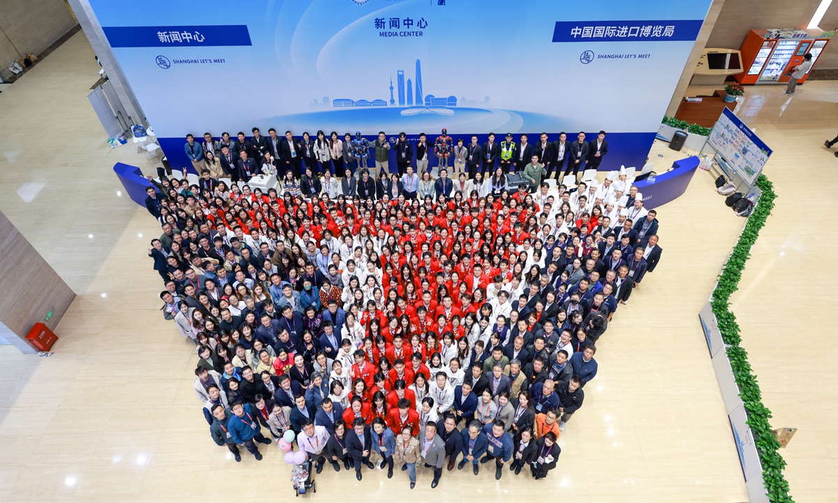 Staff members and volunteers for the 7th China International Import Expo pose for a group photo on November 10, 2024 as the event concludes. Photo: cnsphoto 