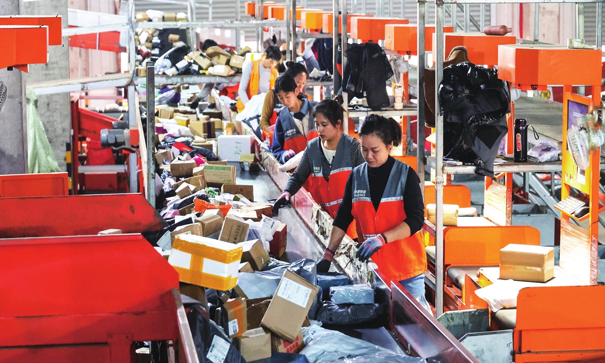 Staff members sort packages at a delivery center in Lianyungang, East China's Jiangsu Province on November 11, 2024, as the 